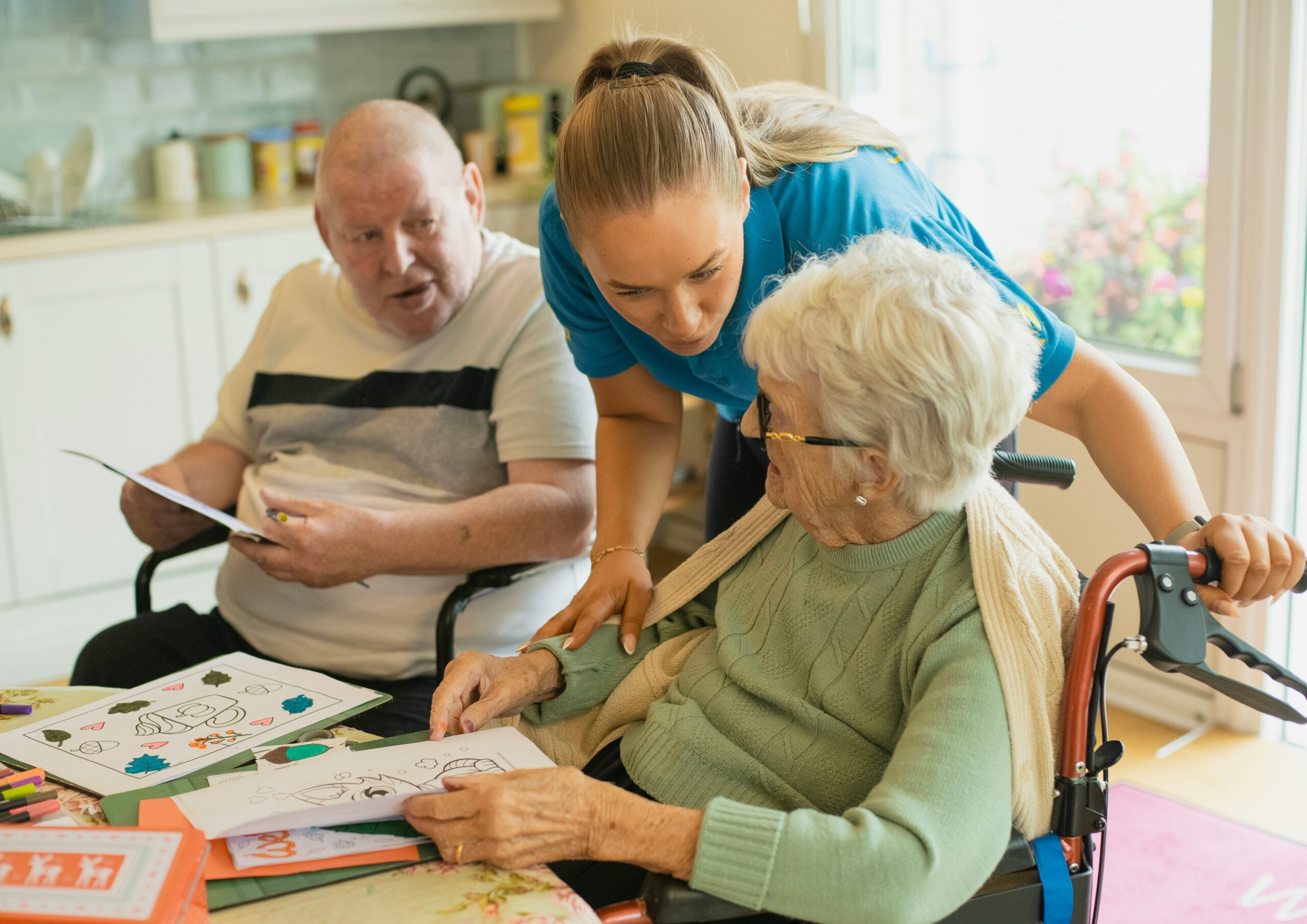 Caregiver assisting an elderly couple at home