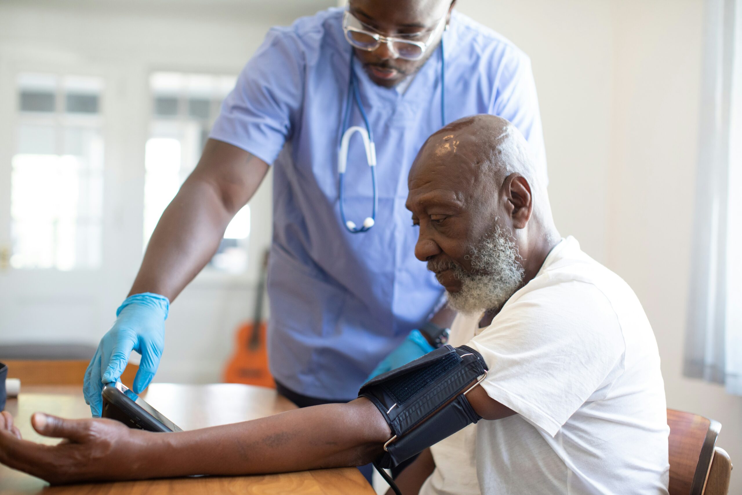 Nurse caring for an elderly patient at home